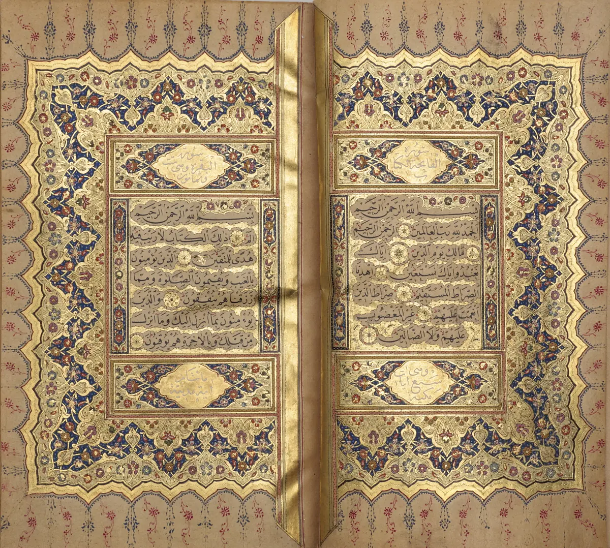 A Qur'an open at two facing pages, the text of each set inside a gilded frame surrounded by coloured floral ornament